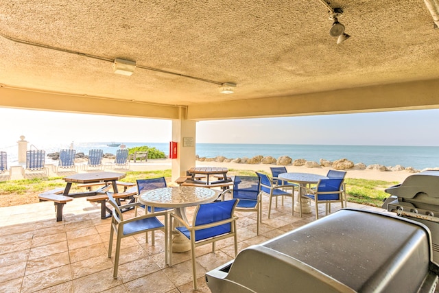 1133 W Ocean Dr Unit 2, Key Colony, FL 33051 - view of patio / terrace featuring grilling area, outdoor dining area, and a water view
