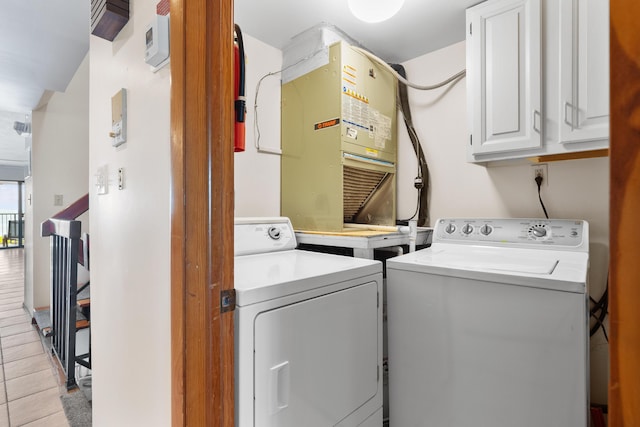 1133 W Ocean Dr Unit 2, Key Colony, FL 33051 - laundry area featuring cabinet space, heating unit, and separate washer and dryer