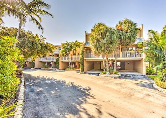 1133 W Ocean Dr Unit 2, Key Colony, FL 33051 - view of front of house with stucco siding, driveway, and a carport