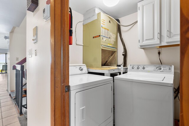 1133 W Ocean Dr Unit 2, Key Colony, FL 33051 - washroom featuring heating unit, separate washer and dryer, and cabinet space