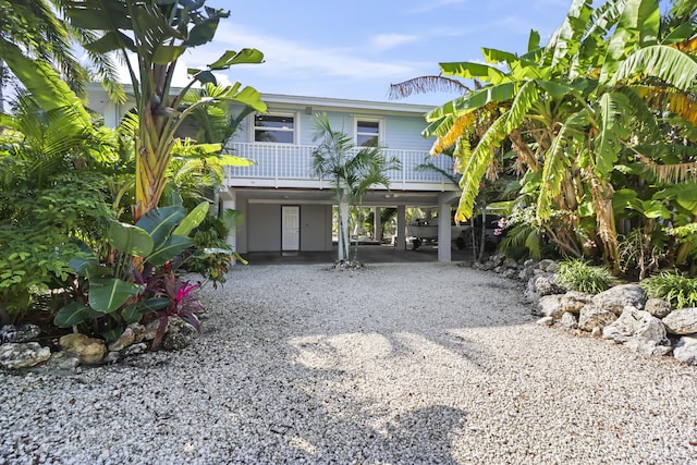 raised beach house featuring a carport