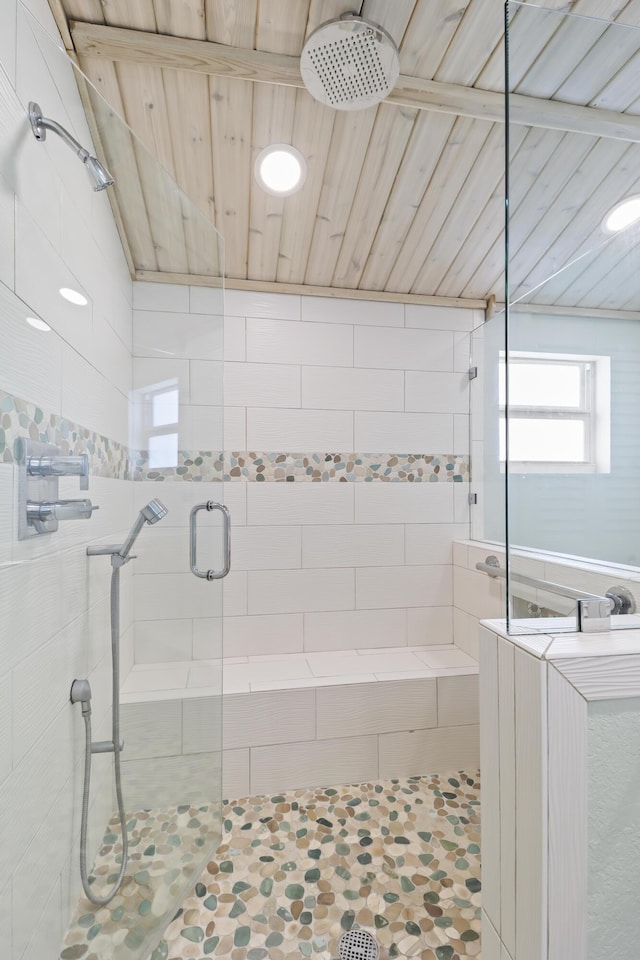 bathroom featuring wooden ceiling and a shower with shower door