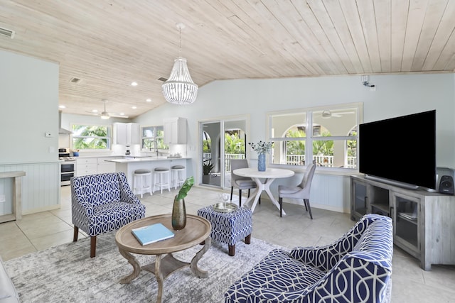 living room featuring lofted ceiling, sink, wooden ceiling, and light tile patterned flooring