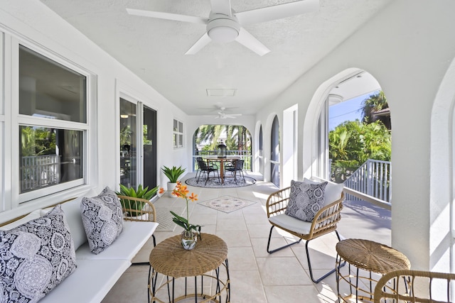 sunroom / solarium featuring ceiling fan