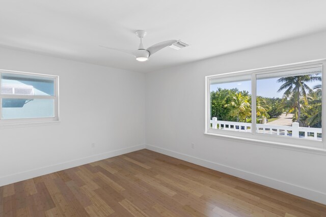 spare room featuring wood-type flooring and ceiling fan