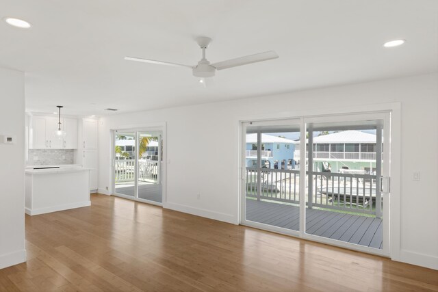 unfurnished living room featuring light hardwood / wood-style flooring and ceiling fan