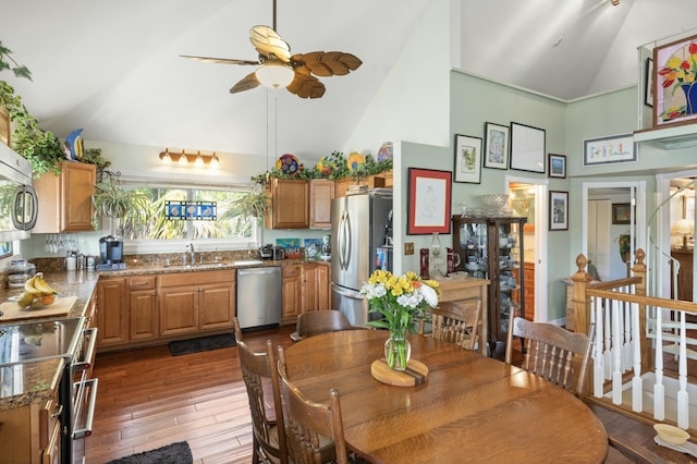 dining room featuring ceiling fan, high vaulted ceiling, dark hardwood / wood-style floors, and sink