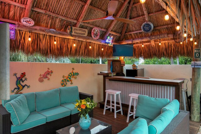 view of patio featuring a bar and an outdoor hangout area