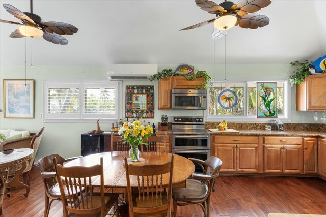 kitchen featuring stainless steel appliances, a wall mounted air conditioner, dark hardwood / wood-style flooring, and dark stone counters