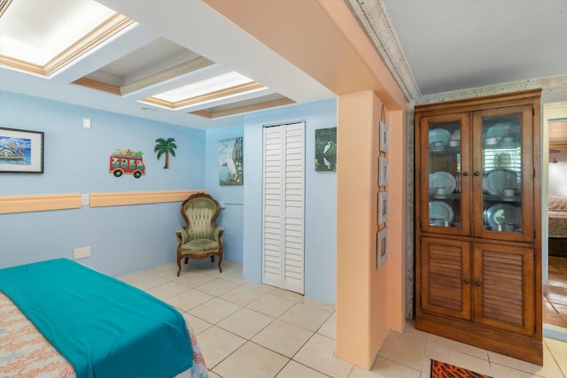 bedroom featuring coffered ceiling, crown molding, beamed ceiling, and light tile patterned flooring