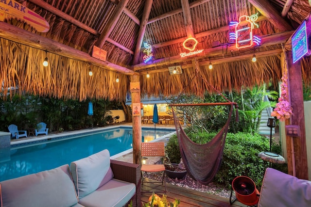 view of swimming pool featuring a gazebo and an outdoor living space