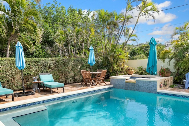 view of pool featuring a hot tub and a patio