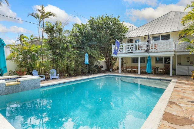 view of pool featuring a hot tub and a patio