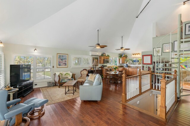 living room featuring a wall mounted air conditioner, dark hardwood / wood-style floors, and high vaulted ceiling