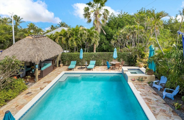 view of pool featuring an in ground hot tub, a gazebo, and a patio area