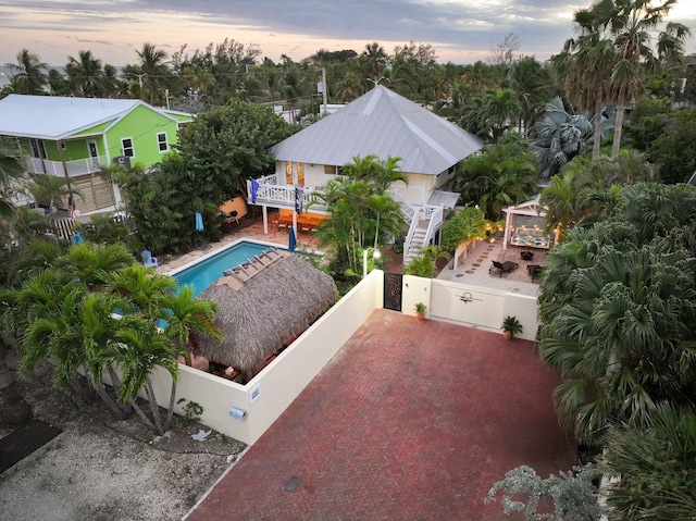 pool at dusk with a gazebo