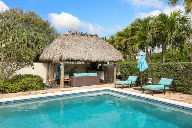 view of swimming pool with a gazebo, an outdoor living space, exterior bar, and a patio