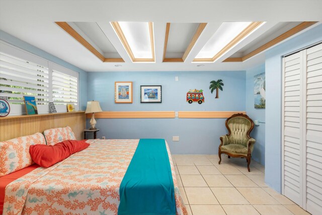 tiled bedroom featuring crown molding and a raised ceiling