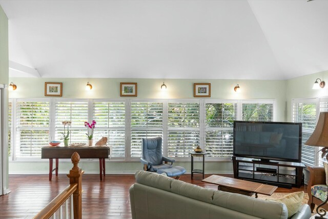 living room with lofted ceiling, hardwood / wood-style floors, and plenty of natural light