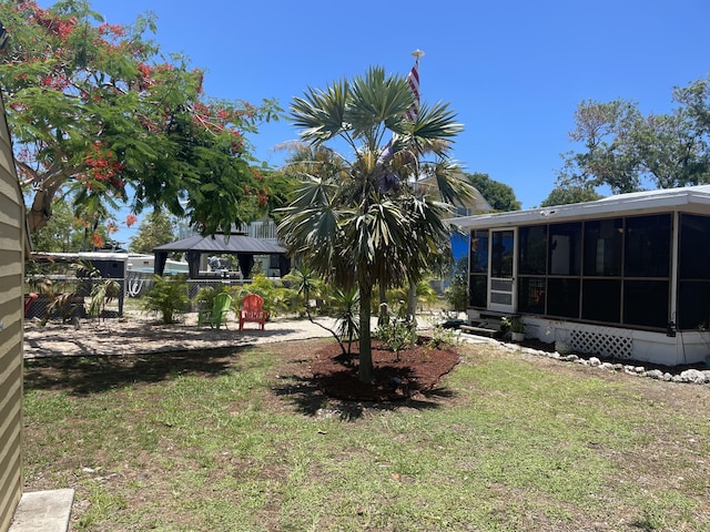 view of yard with a gazebo and a sunroom