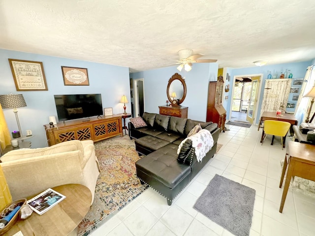 tiled living room featuring a textured ceiling and ceiling fan