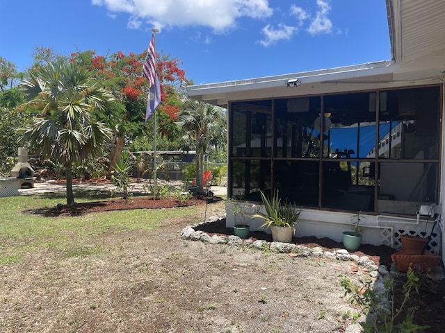 view of yard with a sunroom