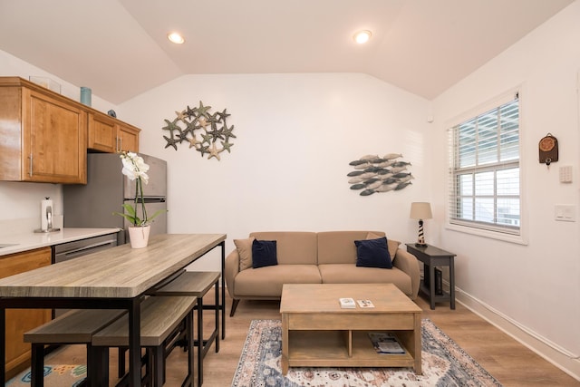 living room with vaulted ceiling and light hardwood / wood-style floors