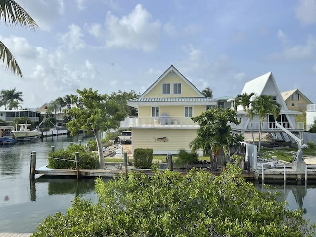 dock area with a balcony and a water view