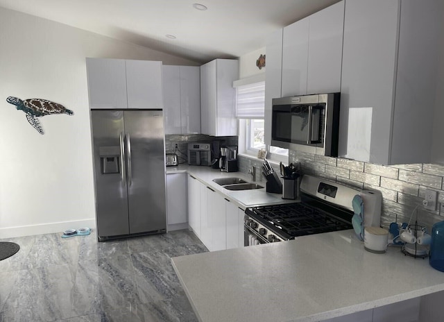 kitchen featuring stainless steel appliances, white cabinetry, and sink