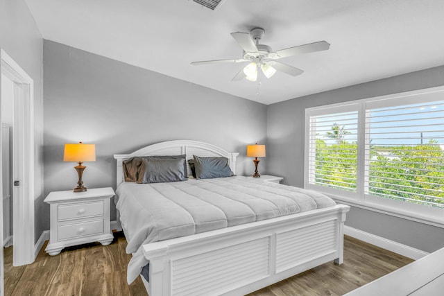 25081 Overseas Hwy, Summerland, FL 33042 - bedroom with baseboards, wood finished floors, and ceiling fan