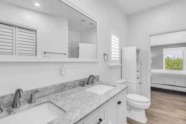 25081 Overseas Hwy, Summerland, FL 33042 - ensuite bathroom with double vanity, wood finished floors, toilet, and a shower with shower door