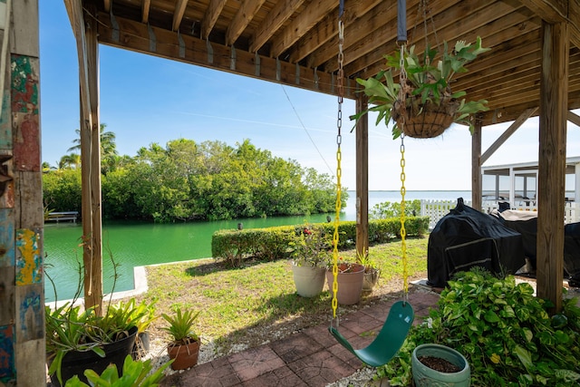 view of patio featuring a water view and area for grilling