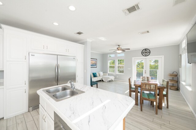 kitchen featuring visible vents, french doors, a sink, and ornamental molding