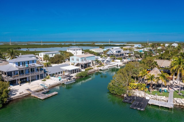 drone / aerial view featuring a water view and a residential view