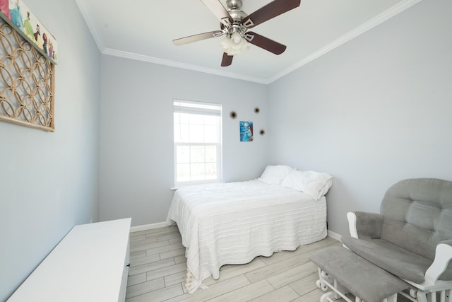 bedroom featuring baseboards, ornamental molding, and wood tiled floor