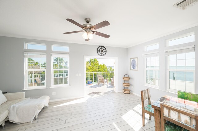 sunroom / solarium featuring visible vents and ceiling fan