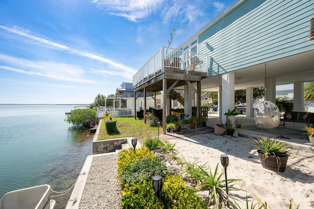 view of patio / terrace with a deck with water view