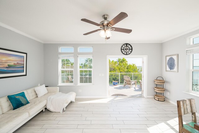 living area featuring crown molding, baseboards, and wood finished floors