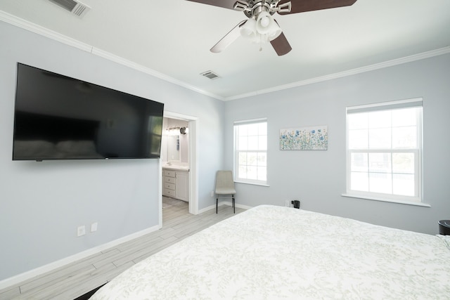 bedroom featuring ornamental molding, light wood-type flooring, and visible vents