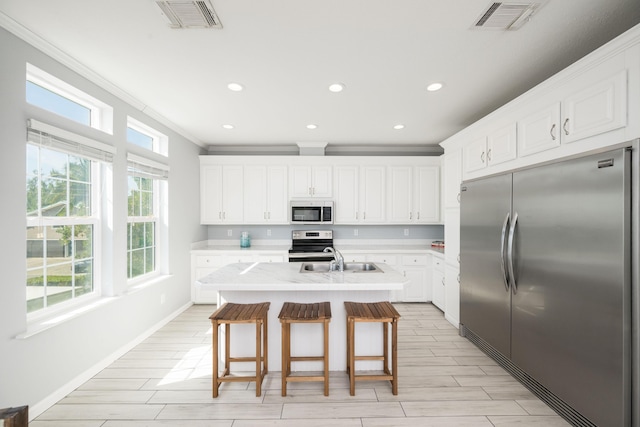 kitchen featuring visible vents, stainless steel appliances, a sink, and light countertops