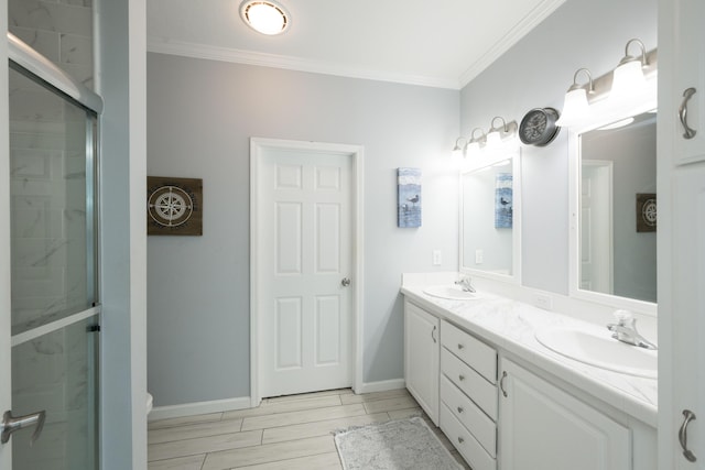 full bathroom featuring double vanity, crown molding, and a sink