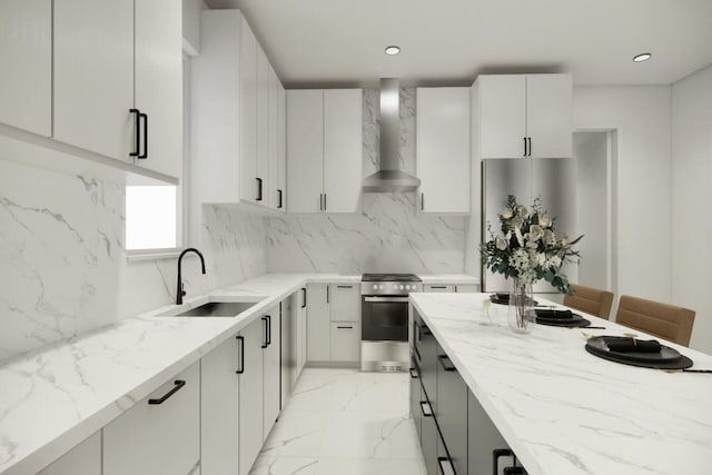 kitchen with wall chimney range hood, sink, refrigerator, light stone counters, and white cabinets