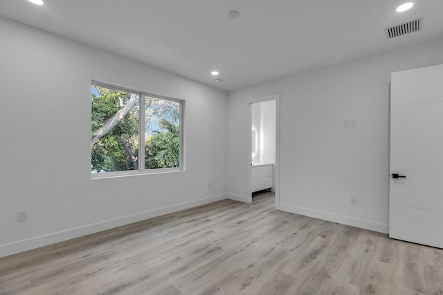 spare room with light hardwood / wood-style floors