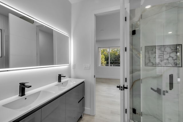 bathroom with vanity, wood-type flooring, and walk in shower