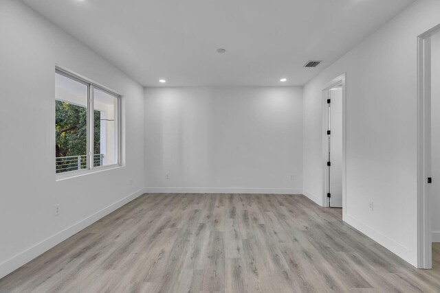 empty room with light hardwood / wood-style flooring