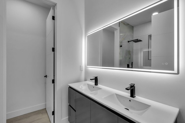 bathroom with vanity, hardwood / wood-style floors, and walk in shower