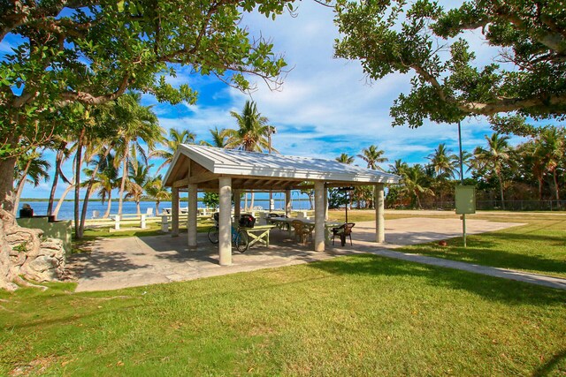 view of community with a gazebo, a water view, and a lawn