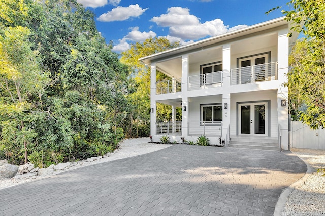 view of front of house with a balcony and french doors