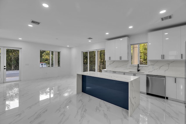 kitchen featuring french doors, tasteful backsplash, fridge, light stone countertops, and white cabinets