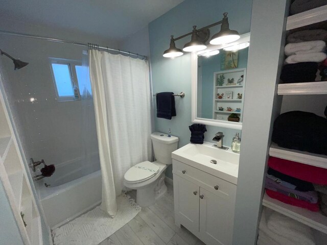 full bathroom featuring vanity, toilet, and shower / tub combo